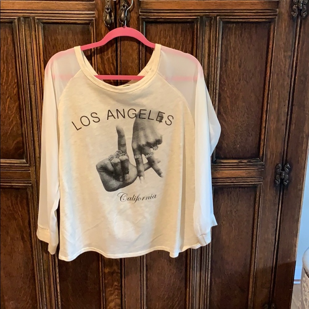 Long sleeve top with sheer sleeves and open back.